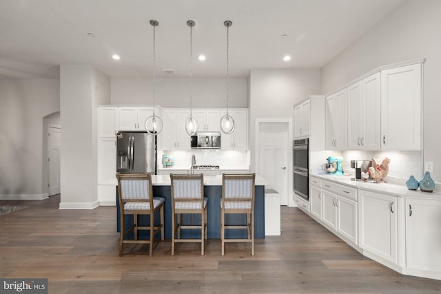 2537 Monarch Way, Bel Air, MD 21015 - kitchen featuring stainless steel appliances, backsplash, white cabinets, an island with sink, and a breakfast bar area