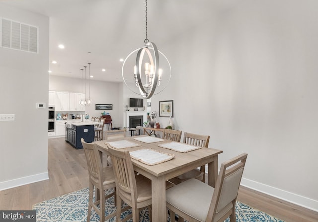2537 Monarch Way, Bel Air, MD 21015 - dining area featuring a chandelier, recessed lighting, light wood finished floors, a fireplace, and baseboards