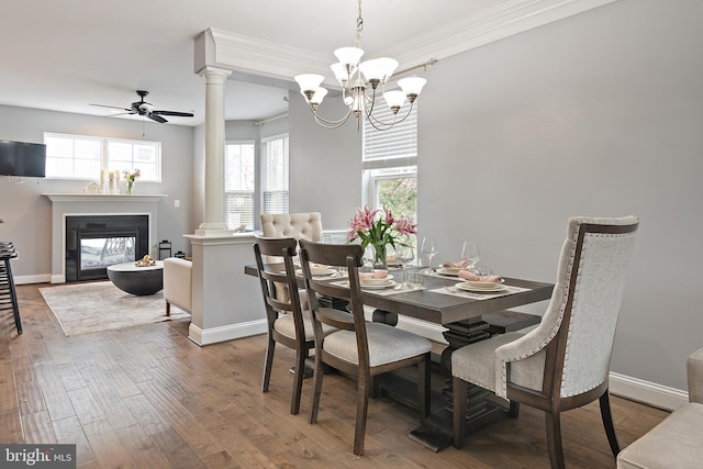 1614 Belle Dr, Annapolis, MD 21401 - dining room with a glass covered fireplace, wood-type flooring, ceiling fan with notable chandelier, and baseboards