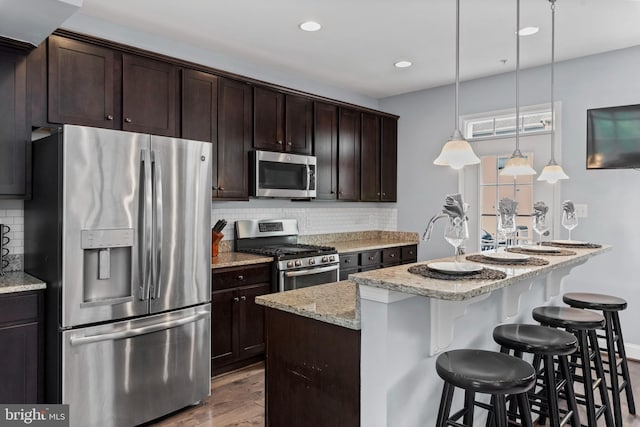 1614 Belle Dr, Annapolis, MD 21401 - kitchen featuring tasteful backsplash, appliances with stainless steel finishes, wood finished floors, and dark brown cabinets