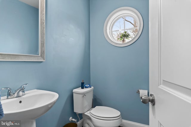 1614 Belle Dr, Annapolis, MD 21401 - half bath featuring a sink, toilet, and baseboards