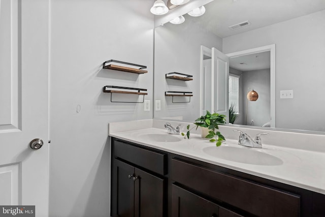 1614 Belle Dr, Annapolis, MD 21401 - full bath featuring toilet, double vanity, a sink, and visible vents