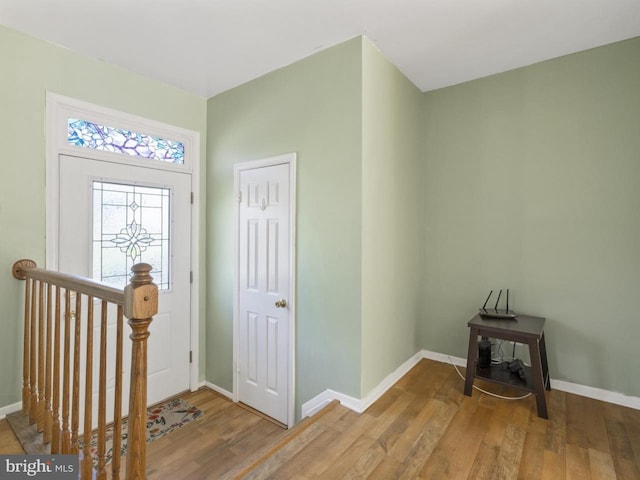 foyer with baseboards and wood finished floors