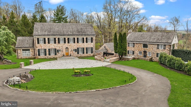 6068 Stoney Hill Rd, New Hope, PA 18938 - colonial inspired home featuring curved driveway, a chimney, and a front yard
