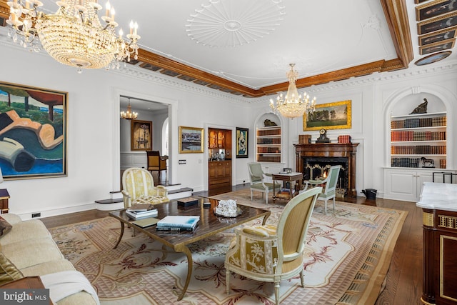 6068 Stoney Hill Rd, New Hope, PA 18938 - living area featuring wood finished floors, ornamental molding, a lit fireplace, a chandelier, and built in features