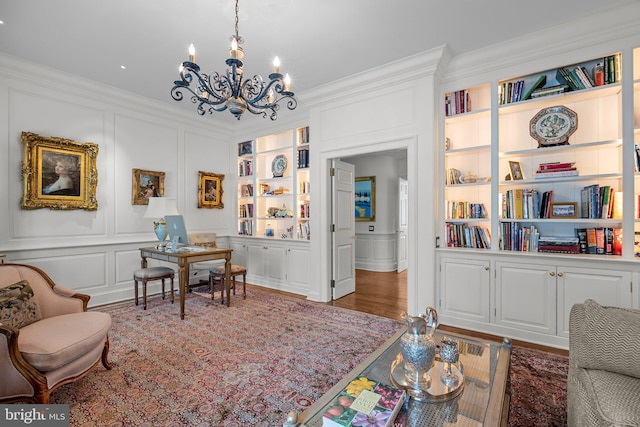 6068 Stoney Hill Rd, New Hope, PA 18938 - sitting room with a chandelier, a decorative wall, built in shelves, and ornamental molding