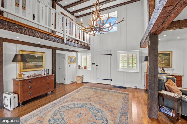 6068 Stoney Hill Rd, New Hope, PA 18938 - entrance foyer with an inviting chandelier, beam ceiling, hardwood / wood-style floors, and plenty of natural light