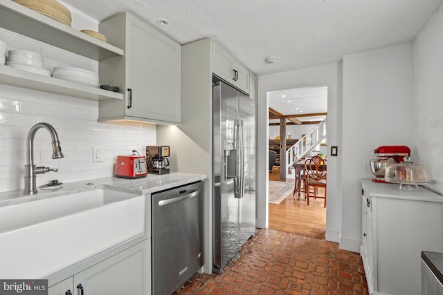 6068 Stoney Hill Rd, New Hope, PA 18938 - kitchen with stainless steel appliances, open shelves, light countertops, a sink, and tasteful backsplash