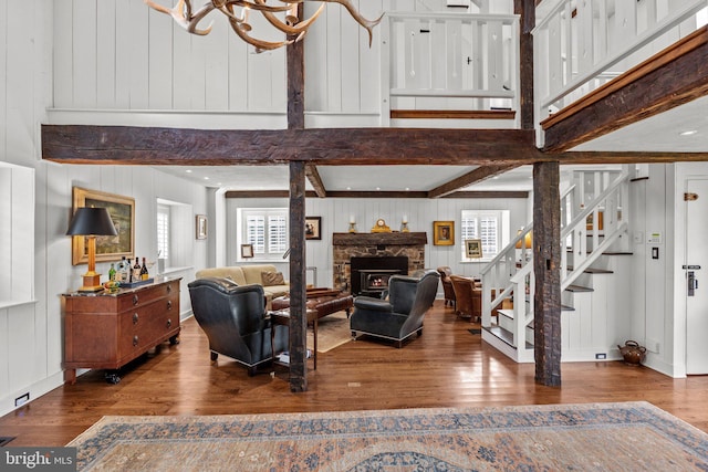 6068 Stoney Hill Rd, New Hope, PA 18938 - living area featuring stairway, beam ceiling, a stone fireplace, and wood finished floors