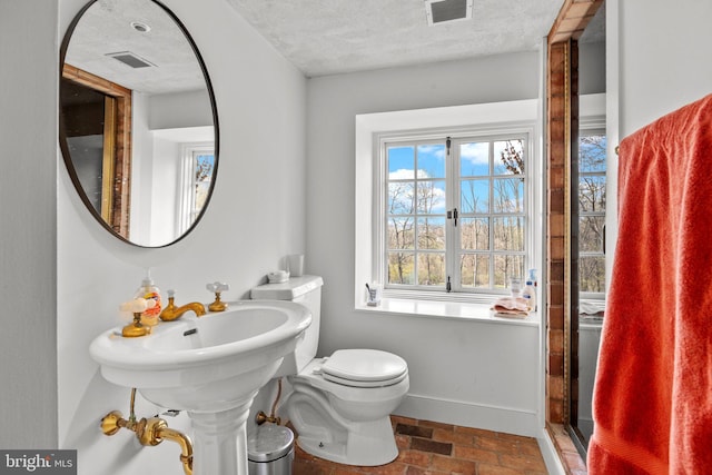 6068 Stoney Hill Rd, New Hope, PA 18938 - bathroom with a textured ceiling, visible vents, toilet, and baseboards