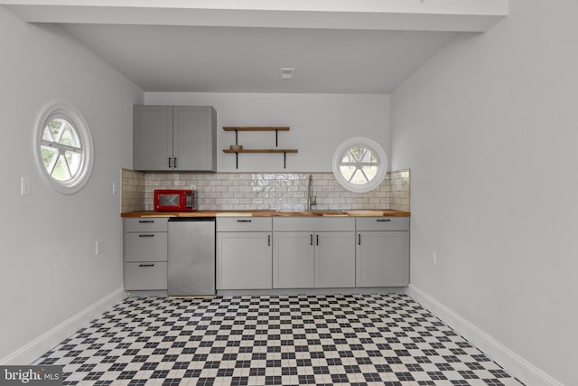 6068 Stoney Hill Rd, New Hope, PA 18938 - kitchen with tile patterned floors, a sink, gray cabinetry, wood counters, and tasteful backsplash