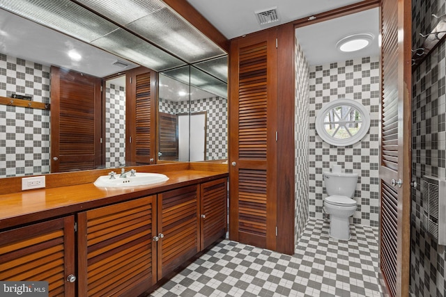 6068 Stoney Hill Rd, New Hope, PA 18938 - bathroom featuring tile walls, visible vents, vanity, and toilet