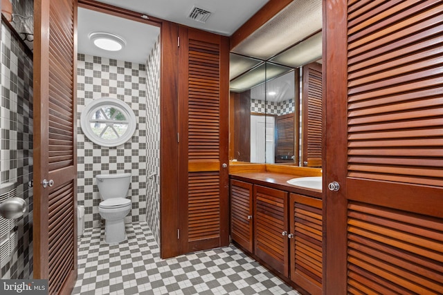 6068 Stoney Hill Rd, New Hope, PA 18938 - bathroom featuring tile patterned floors, visible vents, toilet, vanity, and tile walls