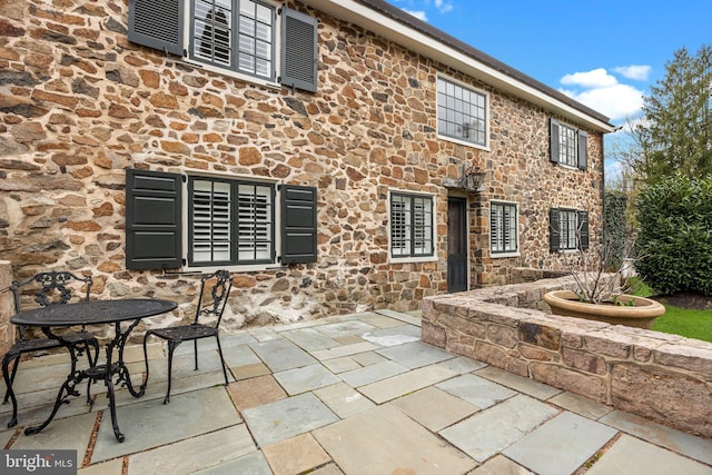 6068 Stoney Hill Rd, New Hope, PA 18938 - back of house with stone siding and a patio