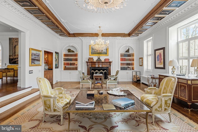 6068 Stoney Hill Rd, New Hope, PA 18938 - sitting room with wood finished floors, crown molding, built in shelves, and an inviting chandelier