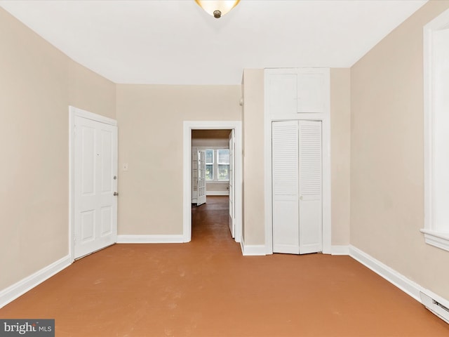 unfurnished bedroom with carpet flooring, baseboards, and a closet