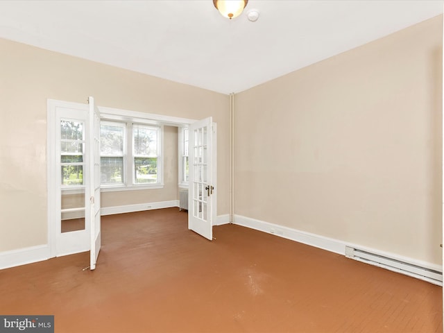 spare room with baseboards and a baseboard heating unit