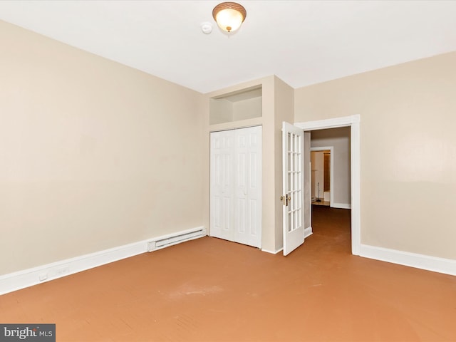 unfurnished bedroom with a closet, a baseboard radiator, carpet, and baseboards