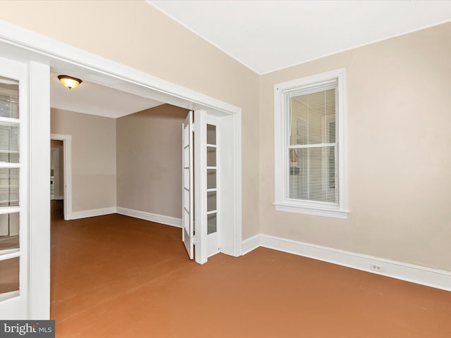 unfurnished room featuring baseboards