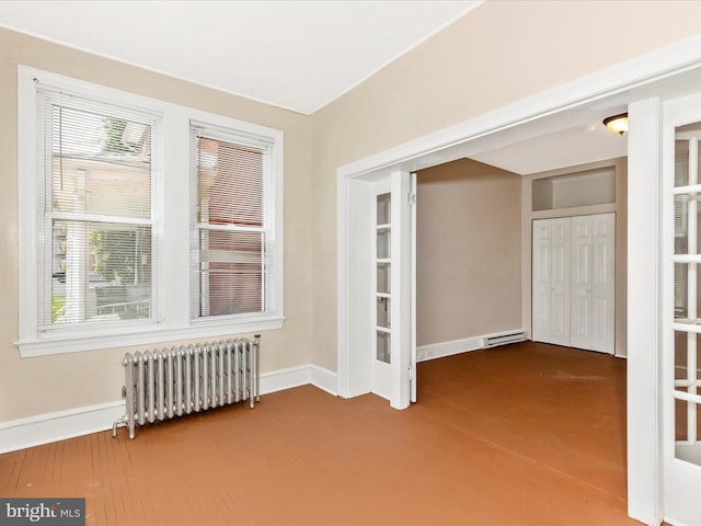 unfurnished room with radiator, baseboards, and visible vents