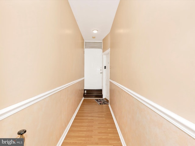 hallway with light wood-style floors and baseboards