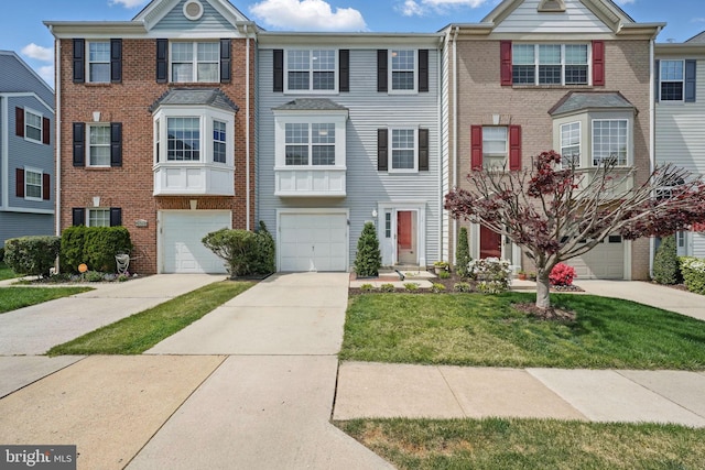 multi unit property with driveway, an attached garage, brick siding, and a front lawn