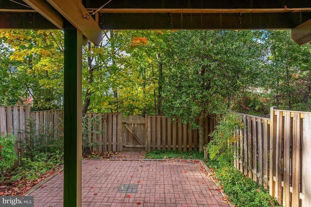 view of patio featuring a fenced backyard and a gate