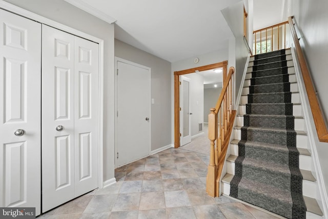 stairs featuring baseboards and stone finish flooring