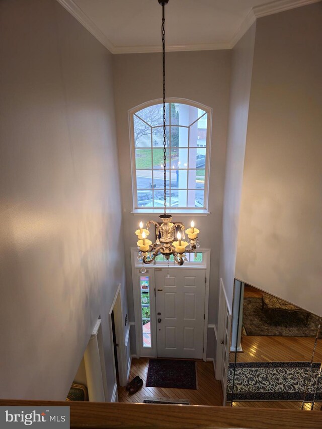 314 Senate Ct, Herndon, VA 20170 - foyer featuring crown molding, plenty of natural light, an inviting chandelier, and wood finished floors