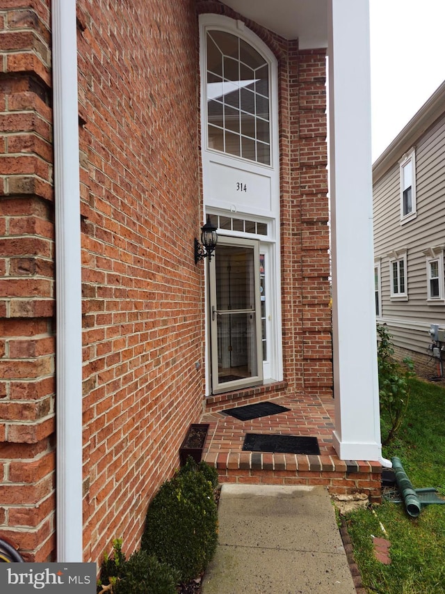 entrance to property with brick siding