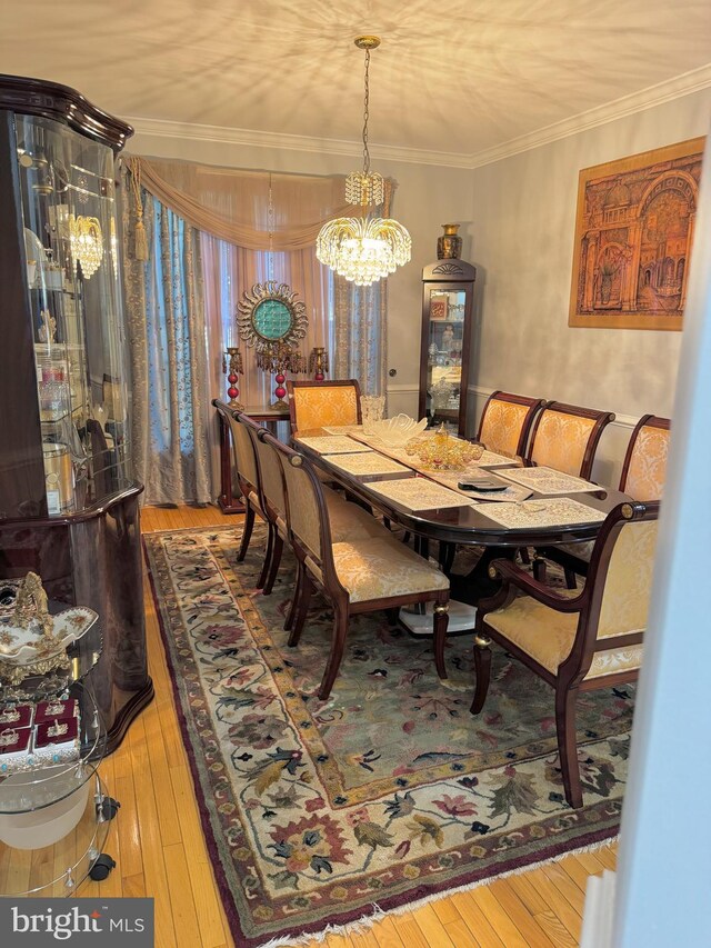 314 Senate Ct, Herndon, VA 20170 - dining room with crown molding, a chandelier, and hardwood / wood-style flooring