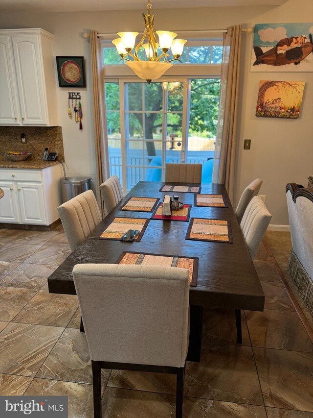 314 Senate Ct, Herndon, VA 20170 - dining room with a chandelier, stone finish floor, and baseboards
