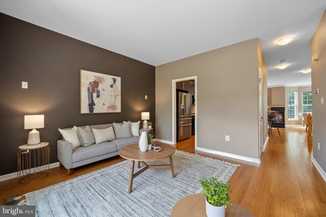 living room featuring wood finished floors and baseboards