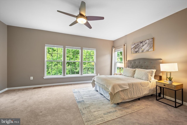 bedroom with carpet floors, baseboards, and a ceiling fan