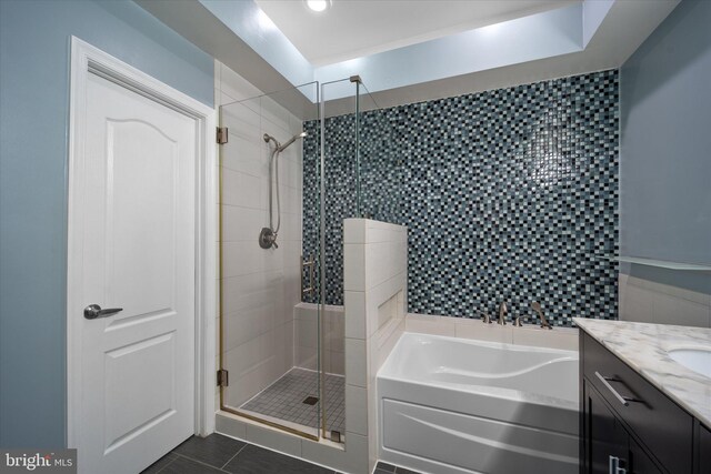 full bath featuring a shower stall, a garden tub, tile patterned flooring, vanity, and recessed lighting
