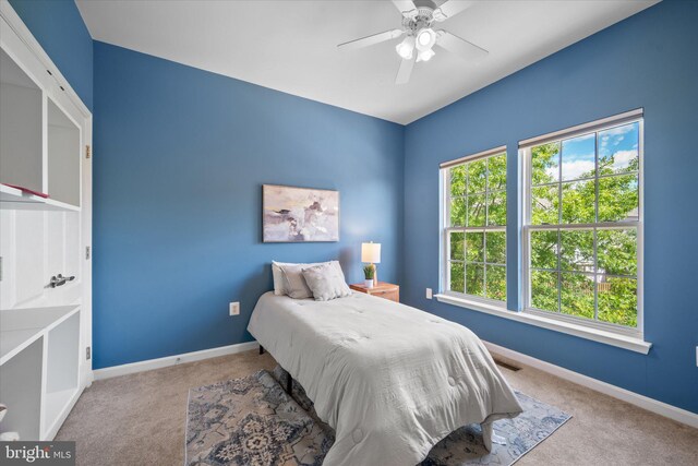 bedroom with carpet, baseboards, and ceiling fan