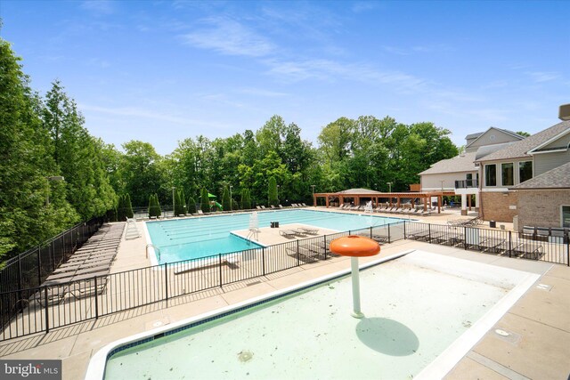 community pool with fence and a patio area