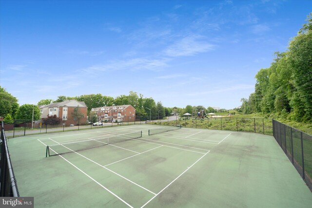 view of tennis court with fence