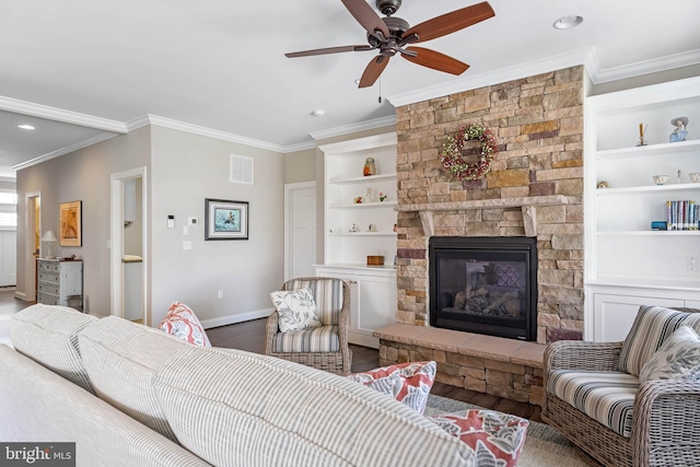 living room with baseboards, visible vents, a ceiling fan, wood finished floors, and crown molding