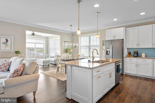kitchen with a healthy amount of sunlight, open floor plan, and a sink