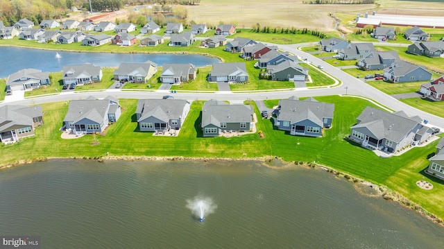 drone / aerial view featuring a residential view and a water view