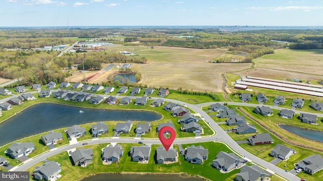 drone / aerial view featuring a residential view and a water view