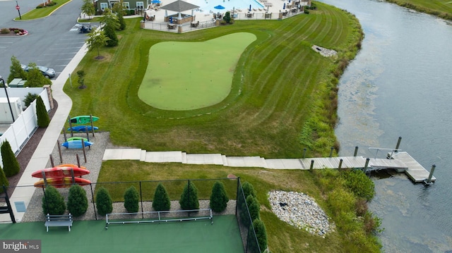 aerial view with golf course view and a water view