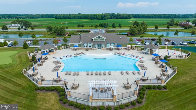 view of swimming pool featuring a water view