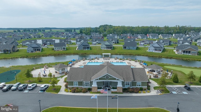 birds eye view of property featuring a water view and a residential view