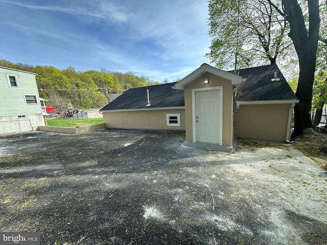 607 N 8th St, Pottsville, PA 17901 - rear view of property with roof with shingles and stucco siding