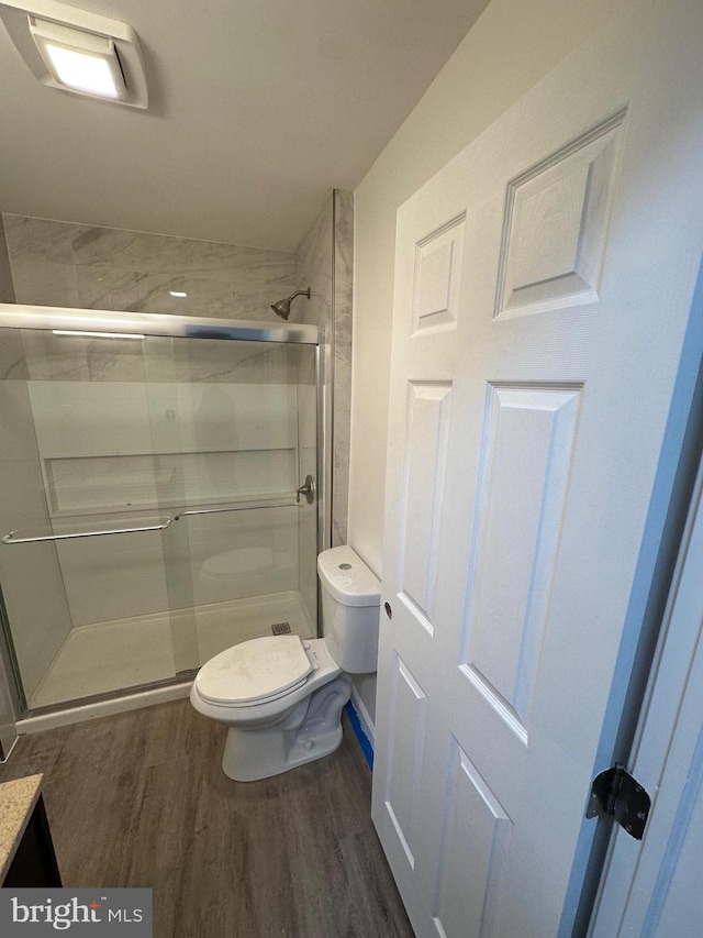 607 N 8th St, Pottsville, PA 17901 - full bath with a shower stall, wood finished floors, and toilet