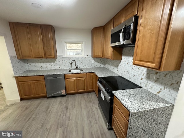 607 N 8th St, Pottsville, PA 17901 - kitchen with brown cabinets, tasteful backsplash, stainless steel appliances, and a sink