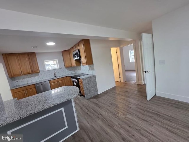 607 N 8th St, Pottsville, PA 17901 - kitchen featuring stainless steel appliances, baseboards, brown cabinets, and dark wood-style floors