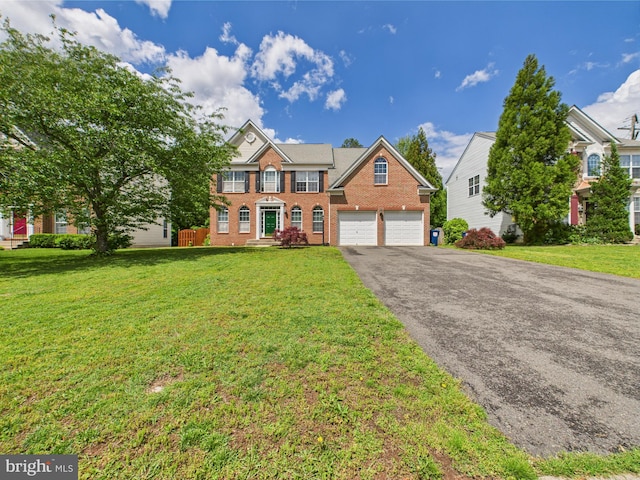 view of front facade with brick siding, asphalt driveway, an attached garage, and a front lawn
